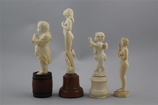 A late 19th century German carved ivory figure standing on a barrel, largest 6.5in. incl. wood plinth